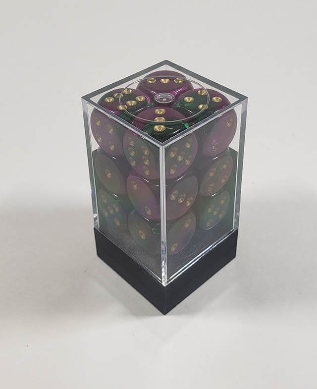 A close up of the Chessex Gemini Green and Purple 16mm d6 dice set in its package.
