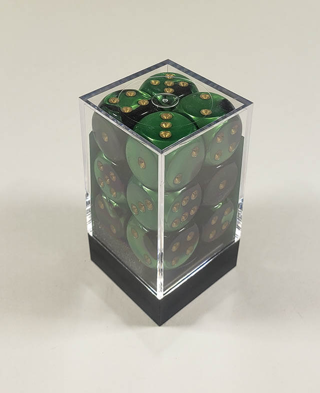 A close up of the Chessex Gemini Black and Green 16mm d6 dice set in its package.