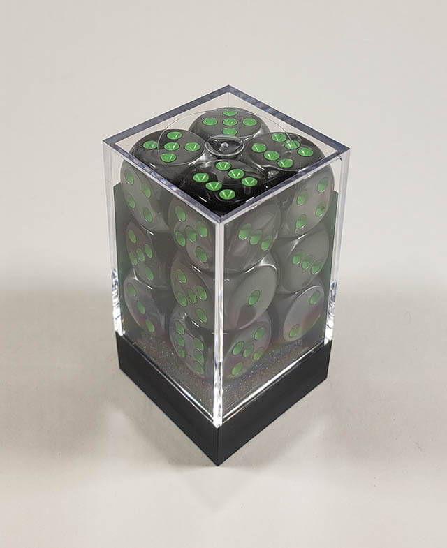 A close up of the Chessex Gemini Black and Grey 16mm d6 dice set in its package.