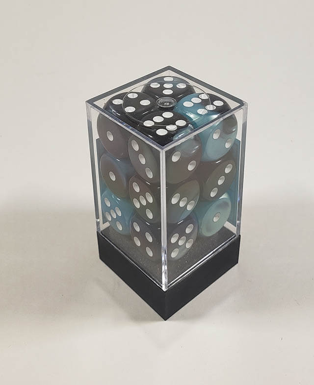 A close up of the Chessex Gemini Black and Shell 16mm d6 dice set in its package.