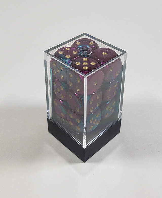 A close up of the Chessex Gemini Purple and teal 16mm d6 dice set in its package.