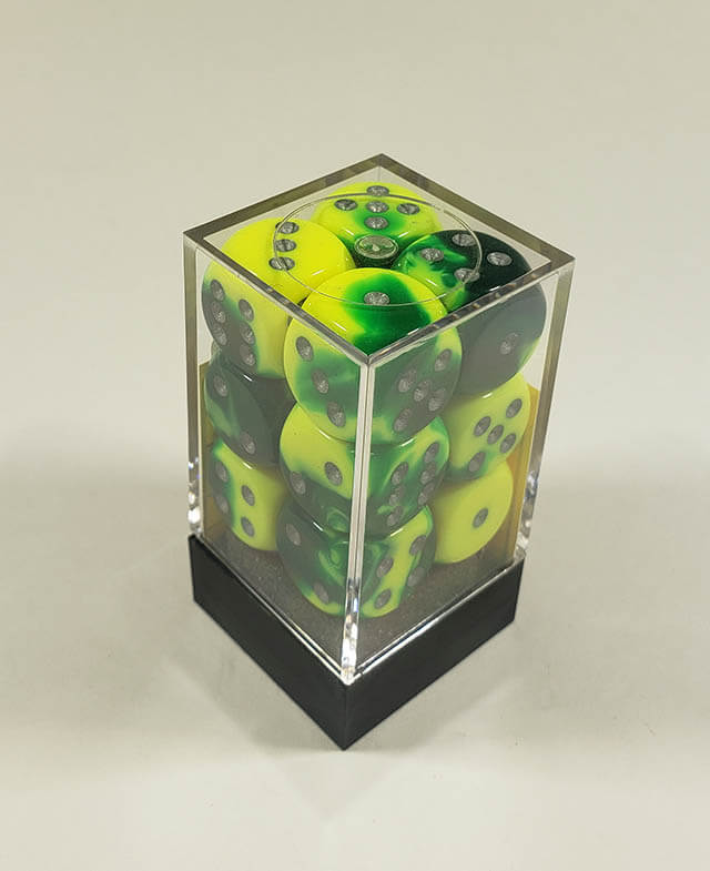 A close up of the Chessex Gemini Green and Yellow 16mm d6 dice set in its package.