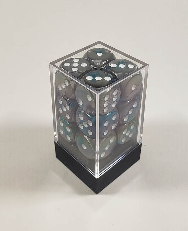 A close up of the Chessex Gemini Steel and Teal 16mm d6 dice set in its package.