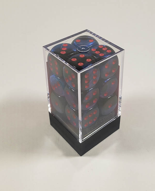 A close up of the Chessex Gemini Black and Starlight 16mm d6 dice set in its package.