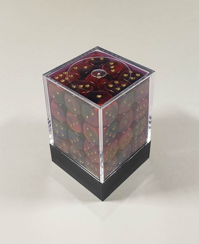 A close up of the Chessex Gemini Purple and Red 12mm d6 dice set in its package.