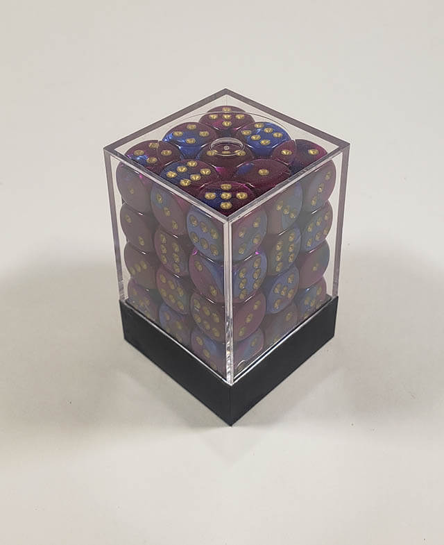 A close up of the Chessex Gemini Blue and Purple 12mm d6 dice set in its package.