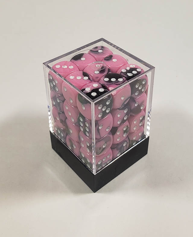 A close up of the Chessex Gemini Black and Pink 12mm d6 dice set in its package.