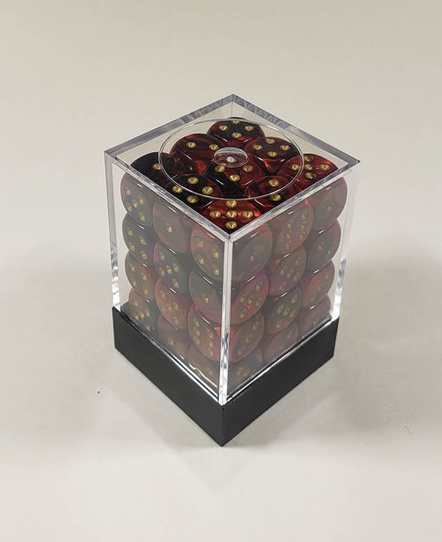 A close up of the Chessex Gemini Black and Red 12mm d6 dice set in its package.