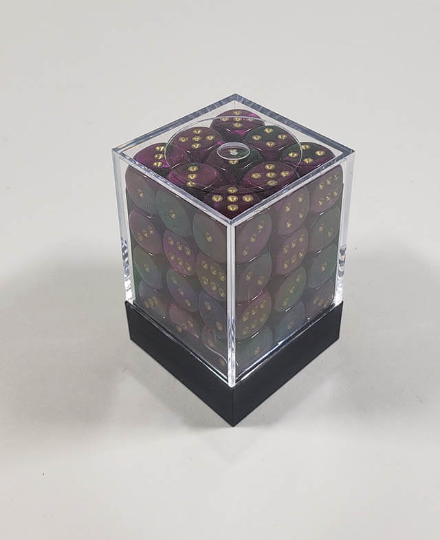 A close up of the Chessex Gemini Green and Purple 12mm d6 dice set in its package.