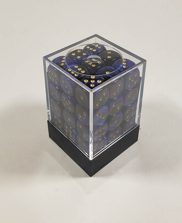 A close up of the Chessex Gemini Black Blue 12mm d6 dice set in its package.