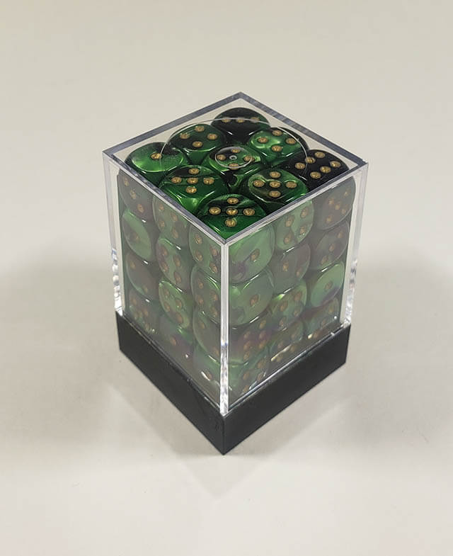A close up of the Chessex Gemini Green and Gold 12mm d6 dice set in its package.