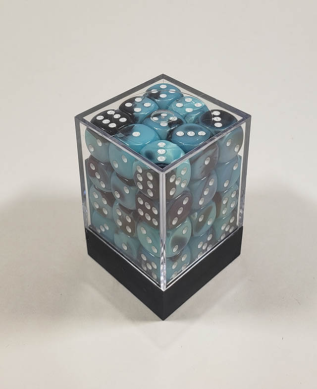 A close up of the Chessex Gemini Black and Shell 12mm d6 dice set in its package.