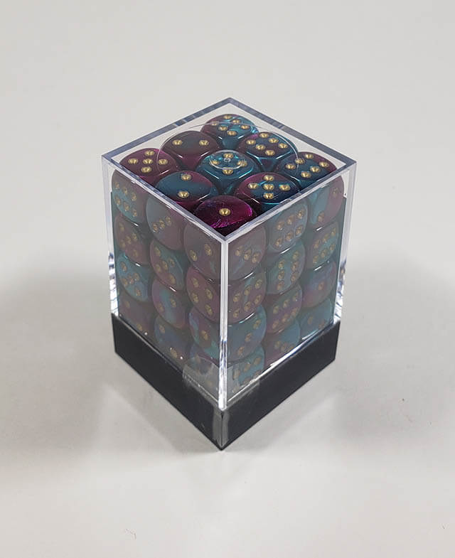 A close up of the Chessex Gemini Purple and Teal 12mm d6 dice set in its package.