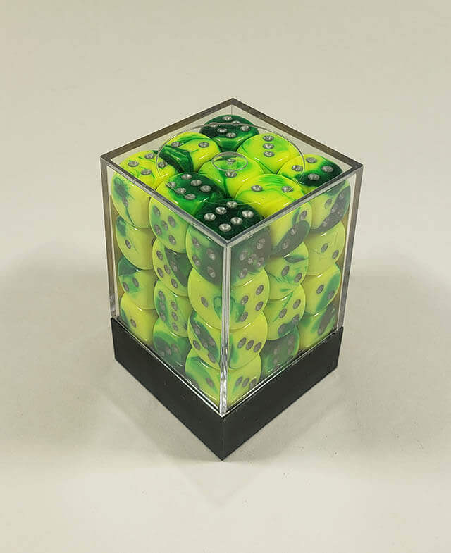 A close up of the Chessex Gemini Green and Yellow 12mm d6 dice set in its package.
