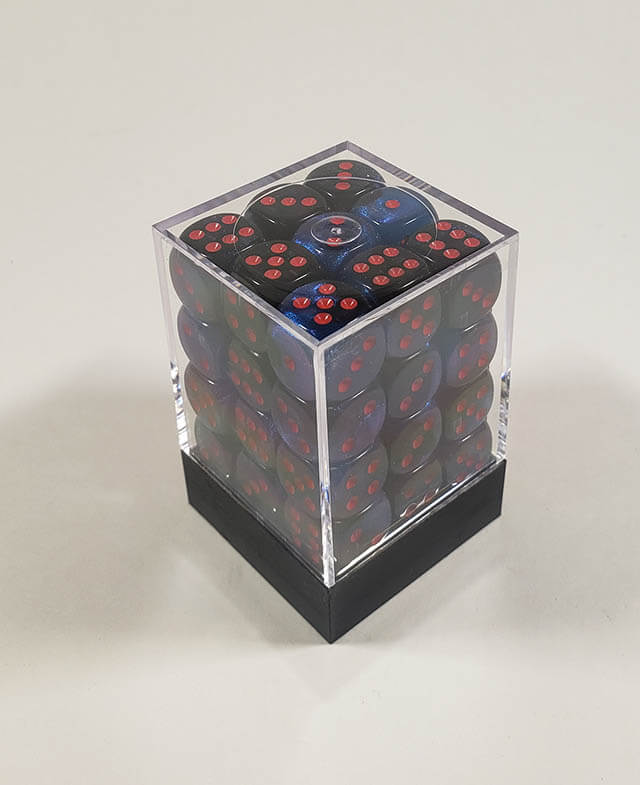 A close up of the Chessex Gemini Black and Starlight 12mm d6 dice set in its package.