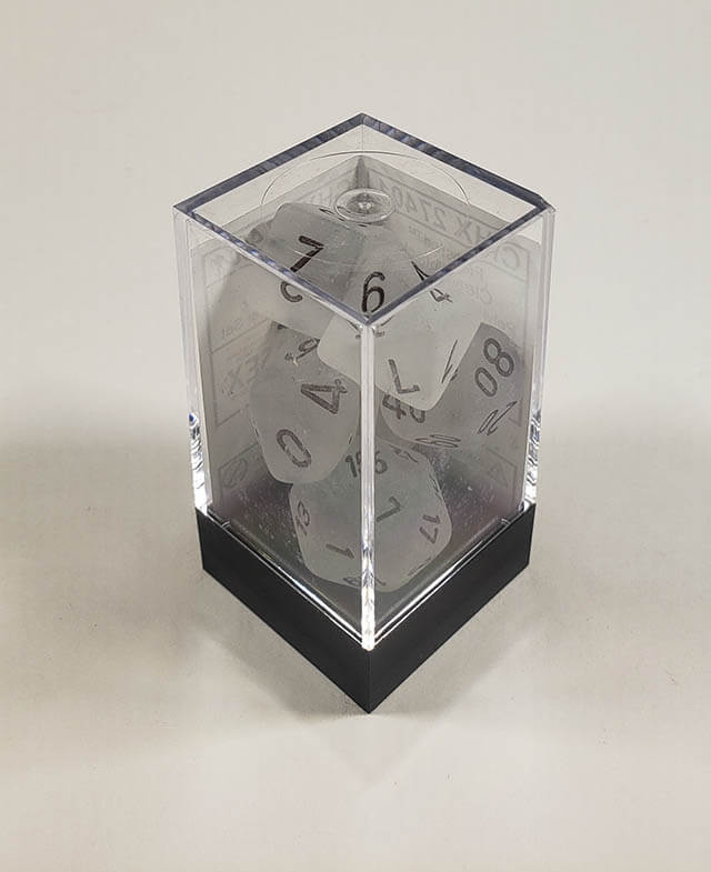 A close up of the Chessex Frosted Clear polyhedral dice set in its package.