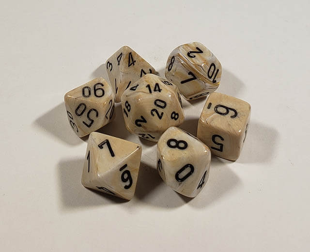 A close up of the Chessex Marble Ivory polyhedral dice set.