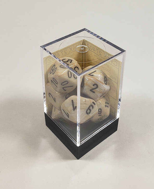A close up of the Chessex Marble Ivory polyhedral dice set in its package.