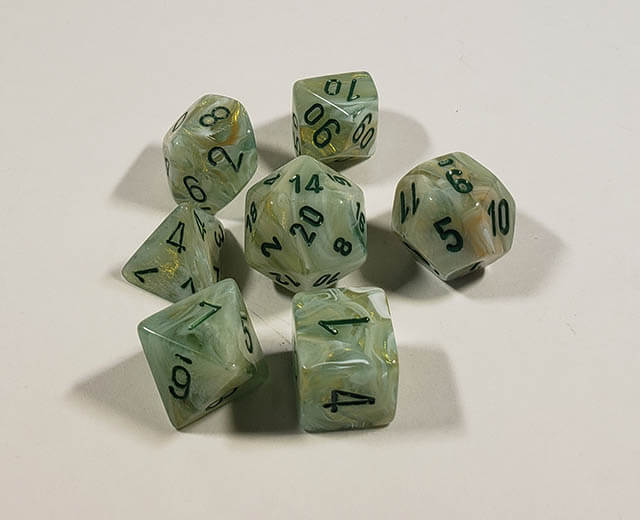 A close up of the Chessex Marble Dark Green polyhedral dice set.