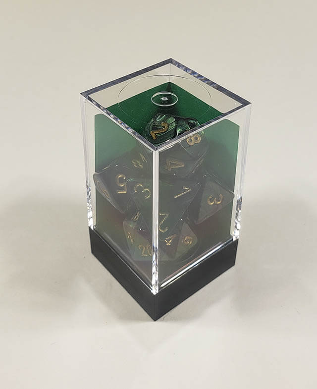 A close up of the Chessex Scarab Jade polyhedral dice set in its package.