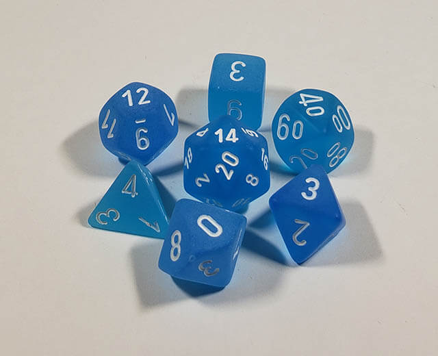 A close up of the Chessex Frosted Caribbean Blue polyhedral dice set in its package.