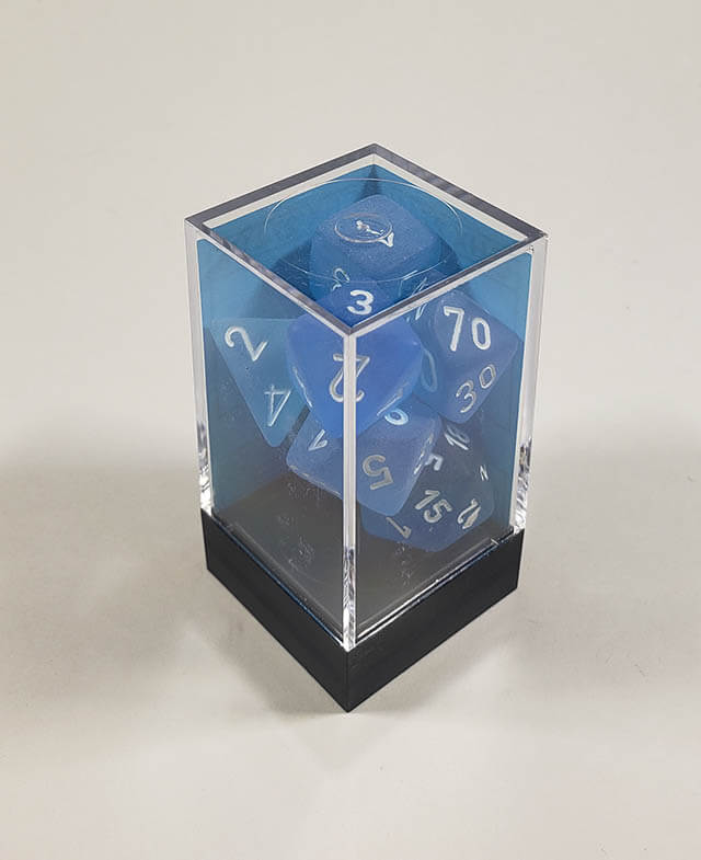 A close up of the Chessex Frosted Carribbean Blue polyhedral dice set in its package.