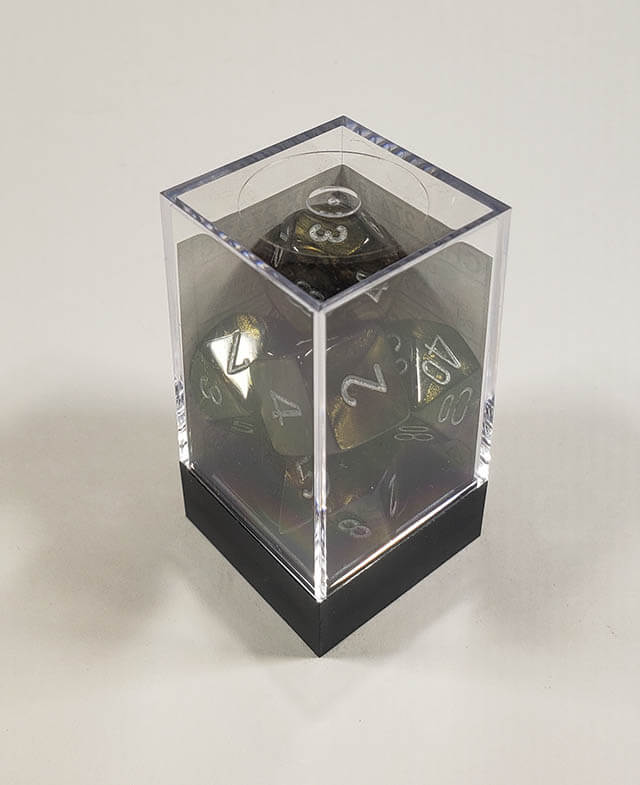 A close up of the Chessex Leaf Black polyhedral dice set in its package.