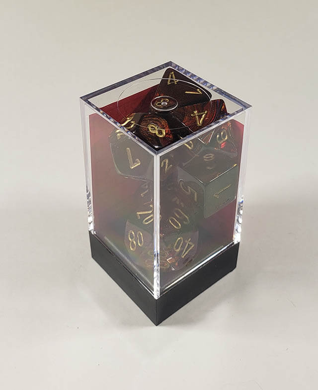 A close up of the Chessex Scarab Blue Blood polyhedral dice set in its package.