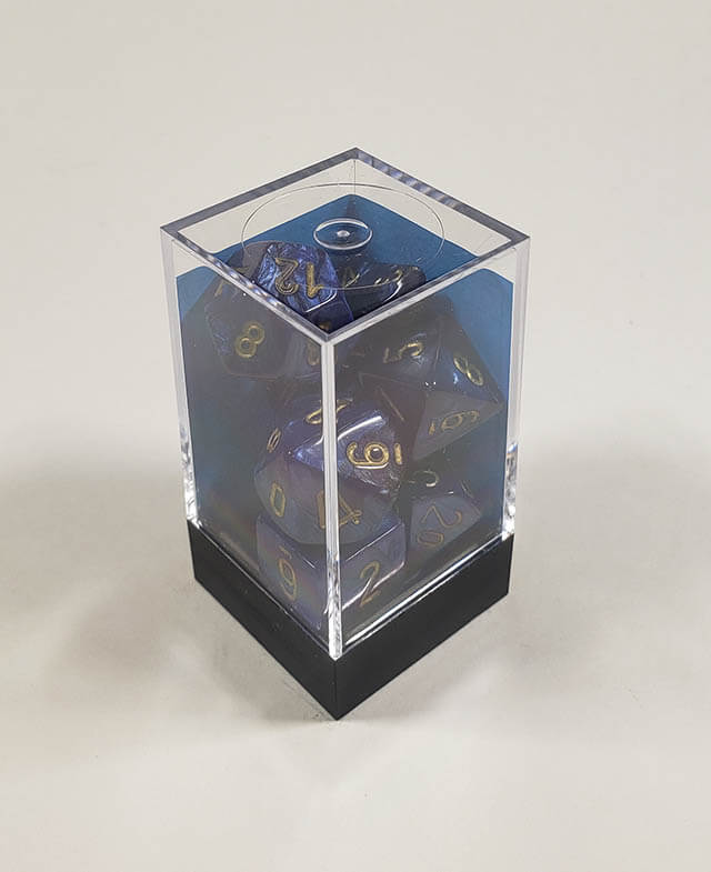 A close up of the Chessex Scarab Scarlet polyhedral dice set in its package.