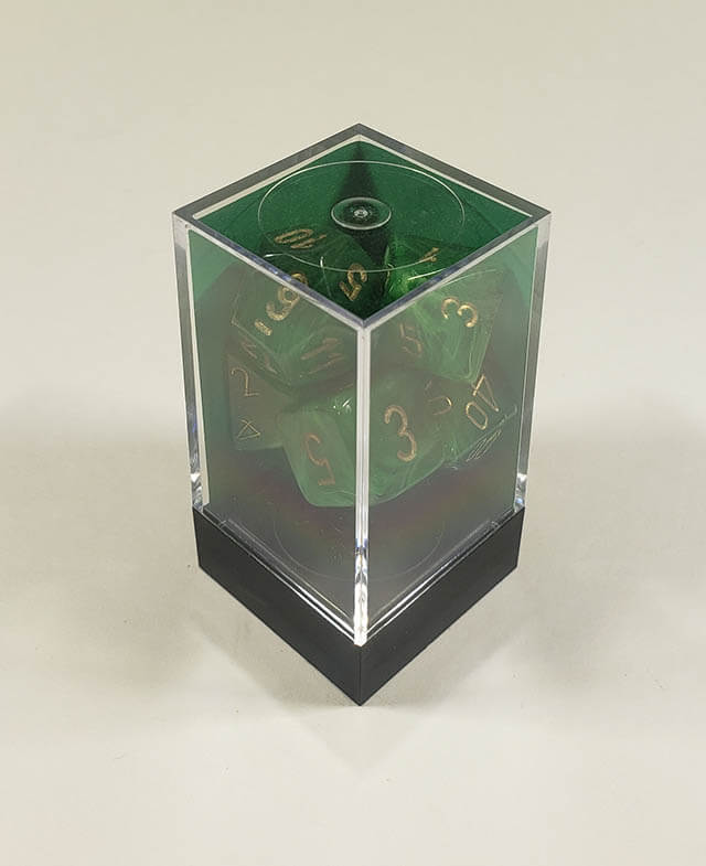 A close up of the Chessex Vortex Green with gold polyhedral dice set in its package.