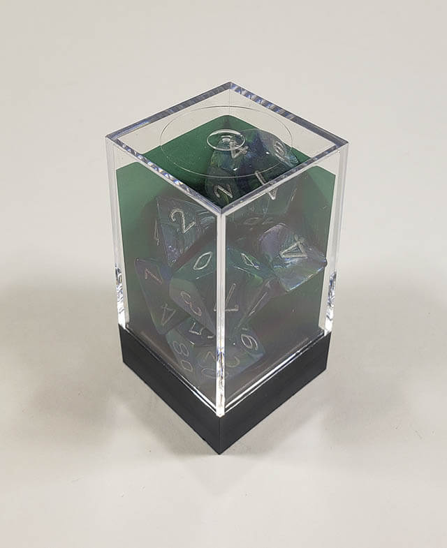 A close up of the Chessex Festive Green polyhedral dice set in its package.