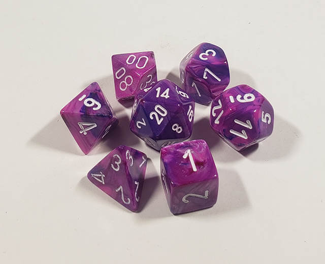 A close up of the Chessex Festive Violet polyhedral dice set.
