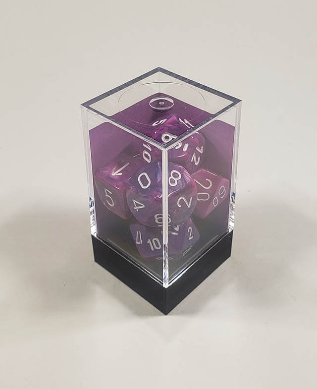 A close up of the Chessex Festive Violet polyhedral dice set in its package.