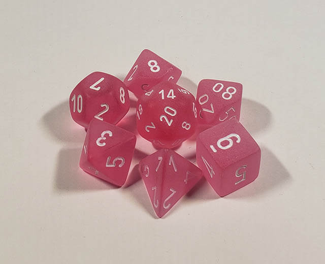 A close up of the Chessex Frosted Pinkpolyhedral dice set.