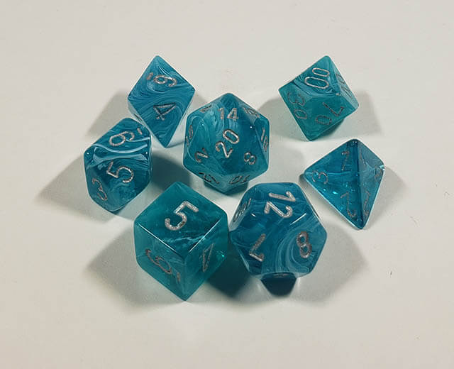 A close up of the Chessex Cirrus Aqua polyhedral dice set.