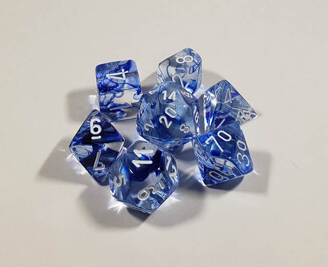 A close up of the Chessex Nebula Dark Blue polyhedral dice set.