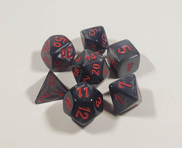 A close up of the Chessex Velvet black with red polyhedral dice set.