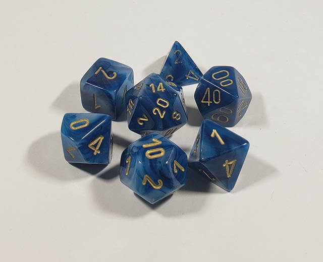 A close up of the Chessex Phantom Teal polyhedral dice set in its package.