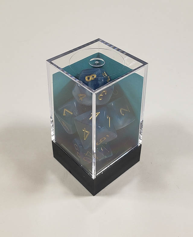 A close up of the Chessex Phantom Teal polyhedral dice set in its package.