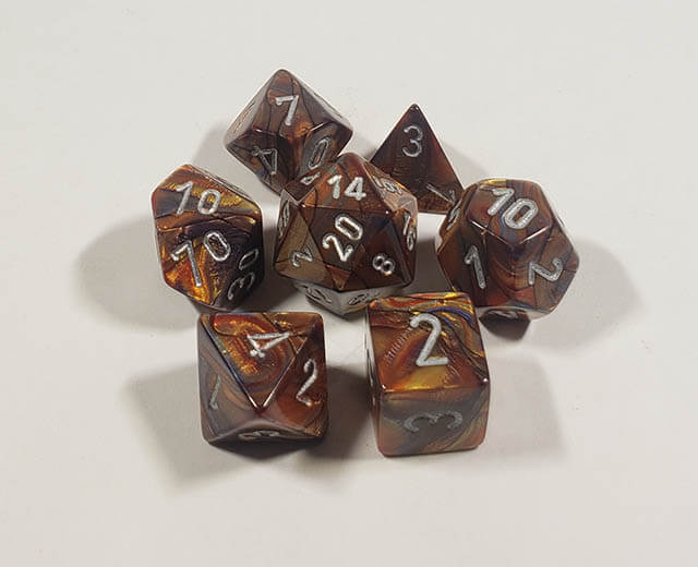 A close up of the Chessex Lustrous Gold polyhedral dice set.
