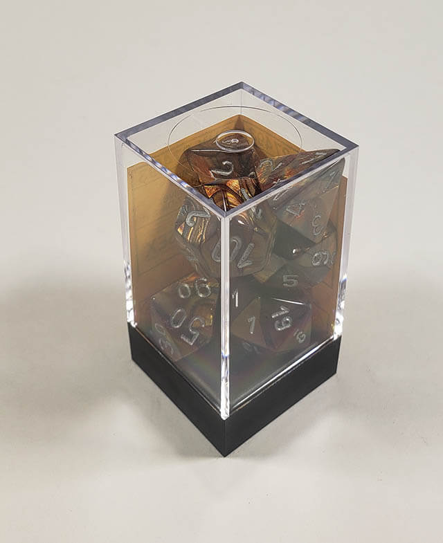 A close up of the Chessex Lustrous Gold polyhedral dice set in its package.