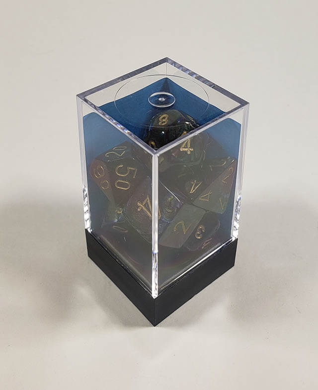 A close up of the Chessex Lustrous Shadow polyhedral dice set in its package.