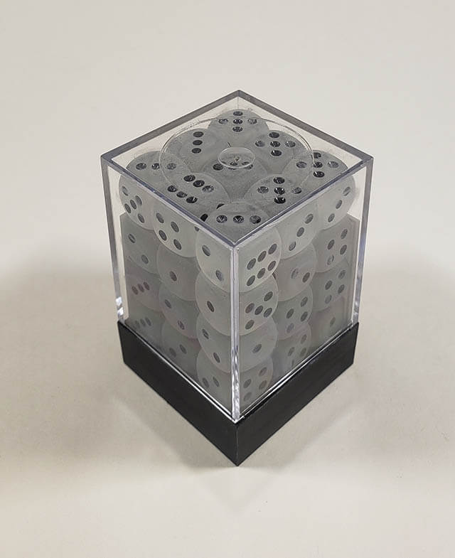 A close up of the Chessex Frosted Clear 12mm d6 dice set in its package.