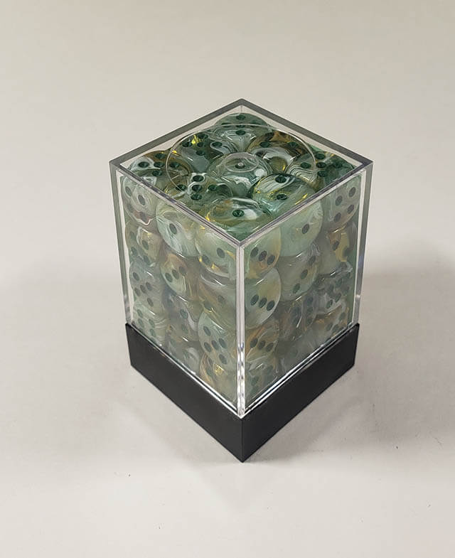 A close up of the Chessex Marble Dark Green 12mm d6 dice set in its package.