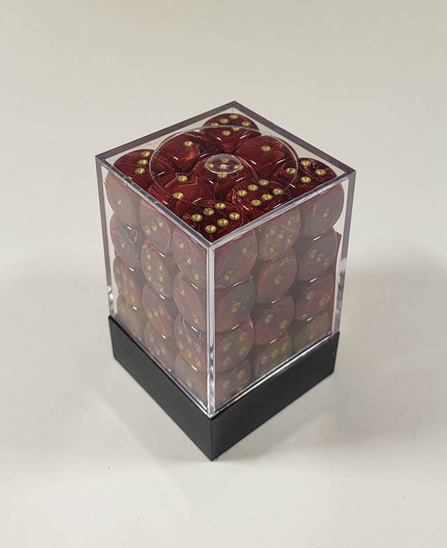 A close up of the Chessex Vortex Burgundy with gold 12mm d6 dice set in its package.