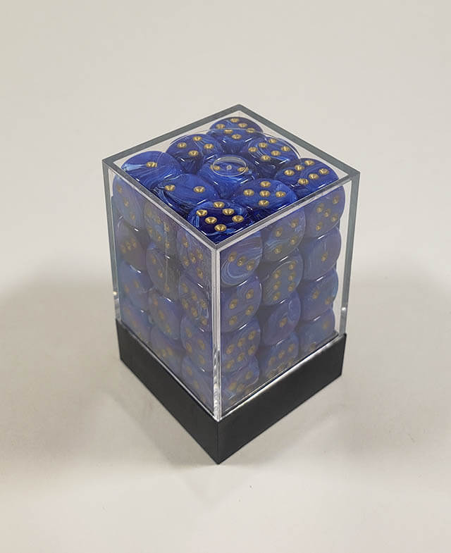 A close up of the Chessex vortex blue with gold12mm d6 dice set in its package.