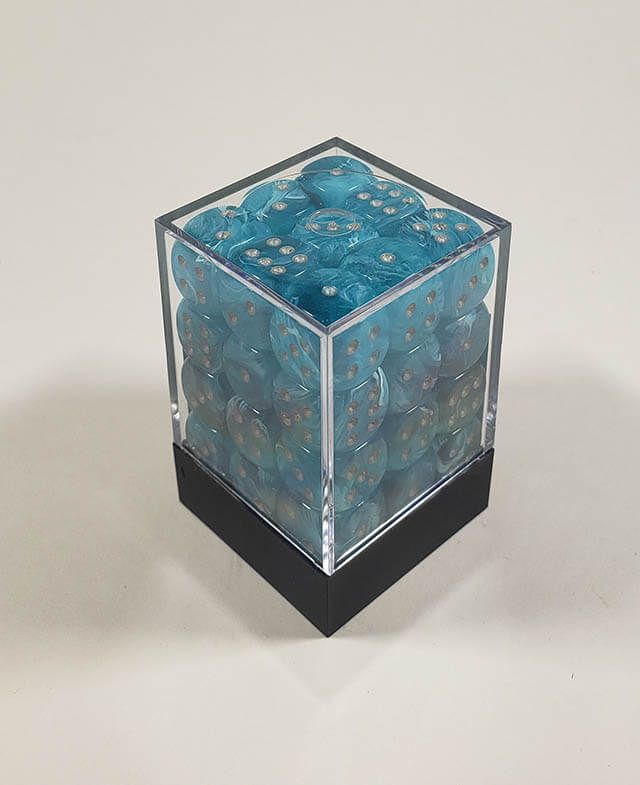 A close up of the Chessex Cirrus Aqua 12mm d6 dice set in its package.