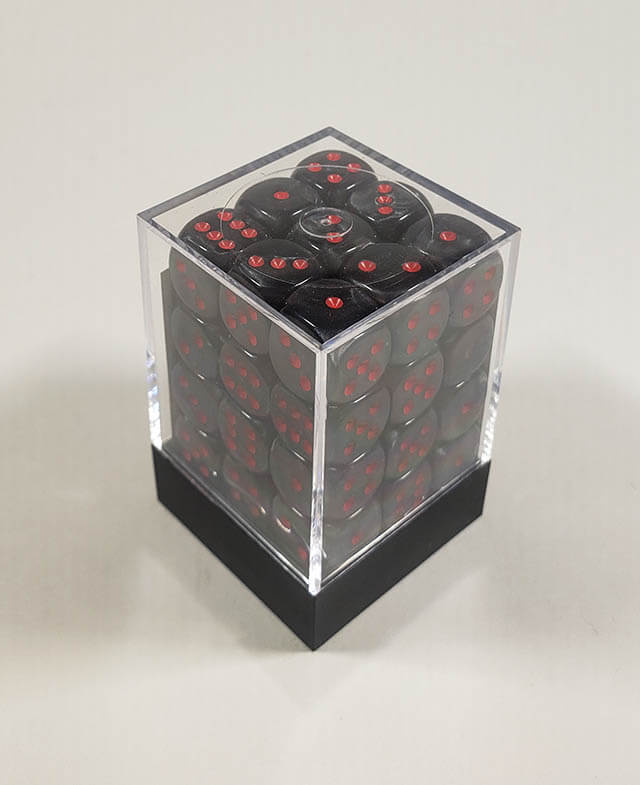 A close up of the Chessex Velvet black with red 12mm d6 dice set in its packaging.