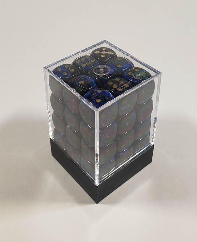 A close up of the Chessex Lustrous Shadow 12mm d6 dice set in its package.