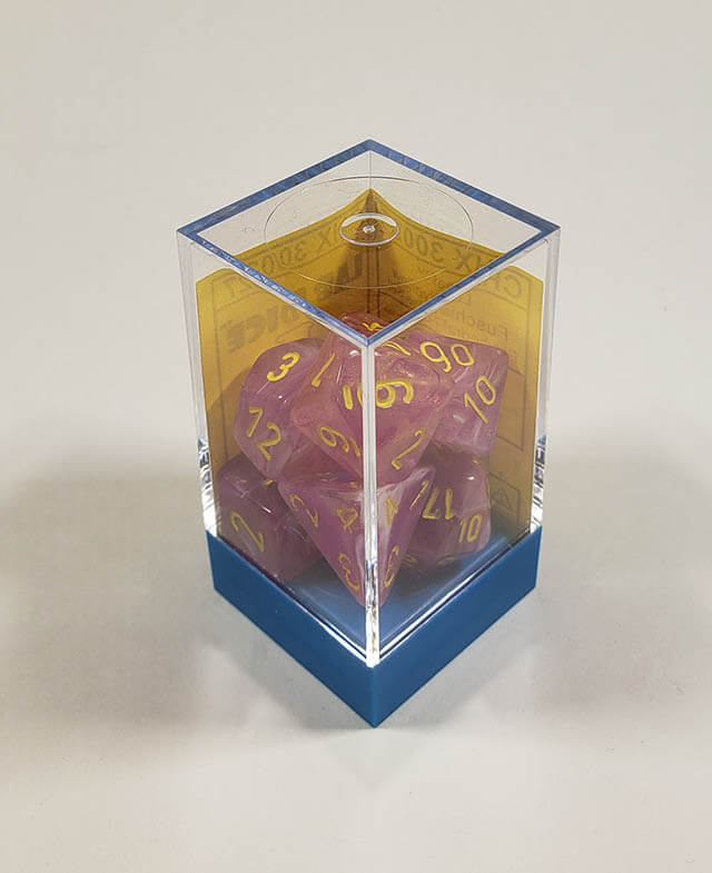 A close up of the Chessex Leaf Fucia polyhedral dice set in its package.